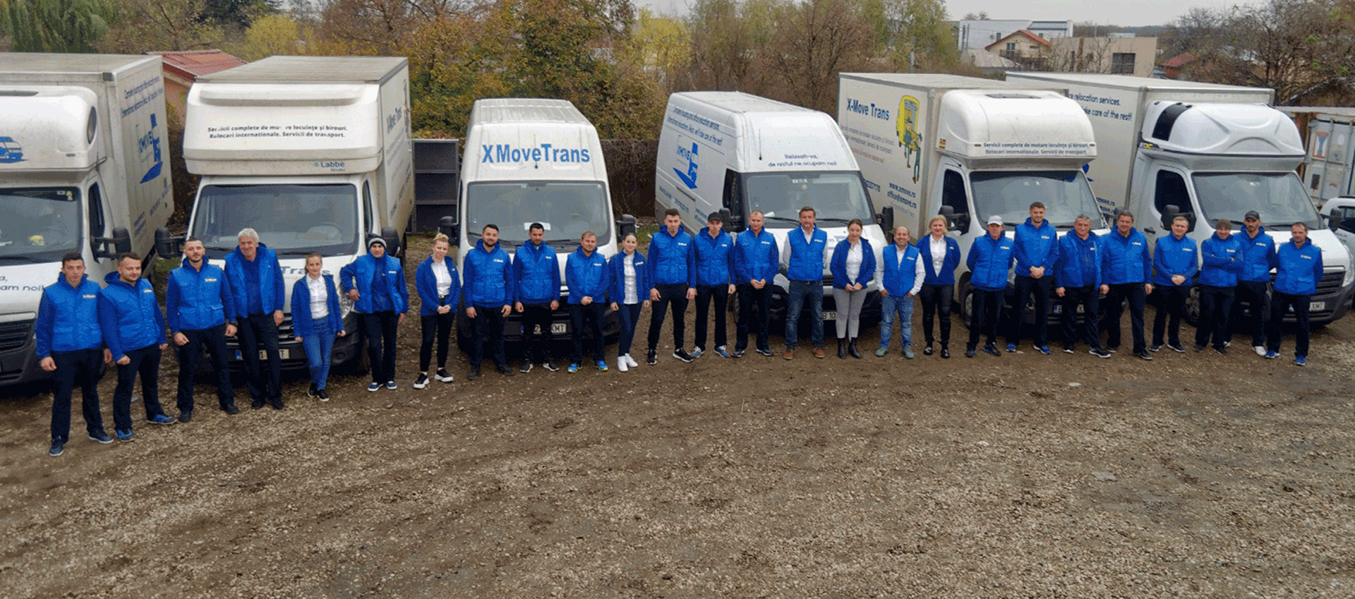 The XMoveTrans team in front of the truck fleet